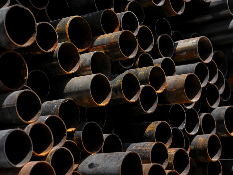 Refrigerant cylinders and HVAC supplies stocked on the wall at Advanced AC Supply in Houston